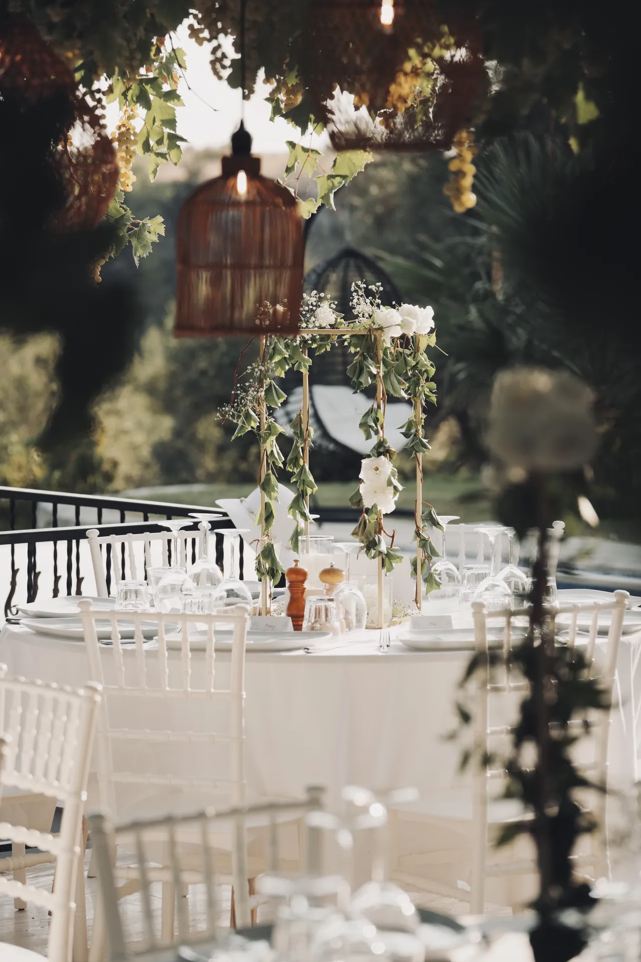 Decorative birdcage centerpiece with greenery garlands