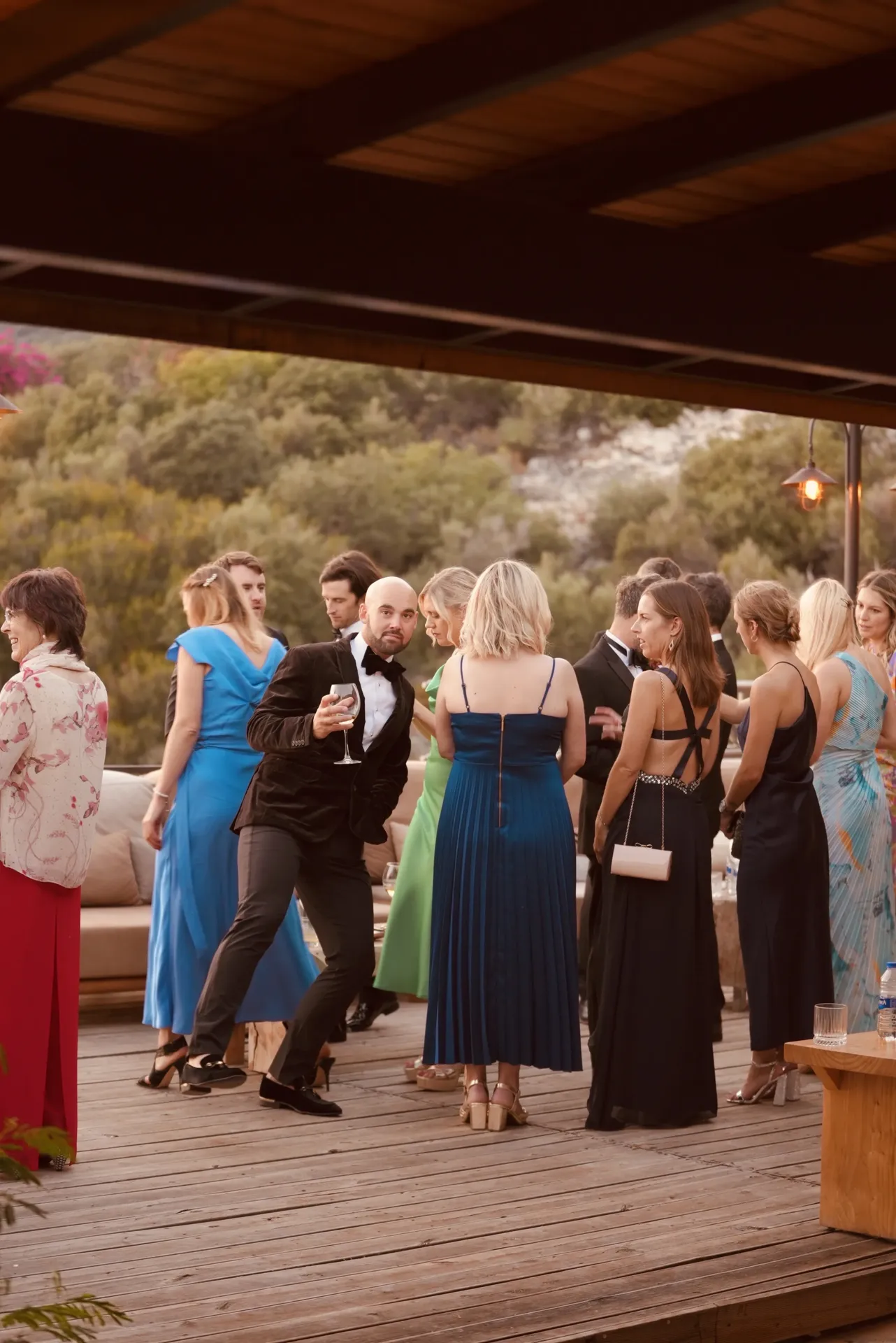 Evening cocktail hour with guests on wooden deck venue