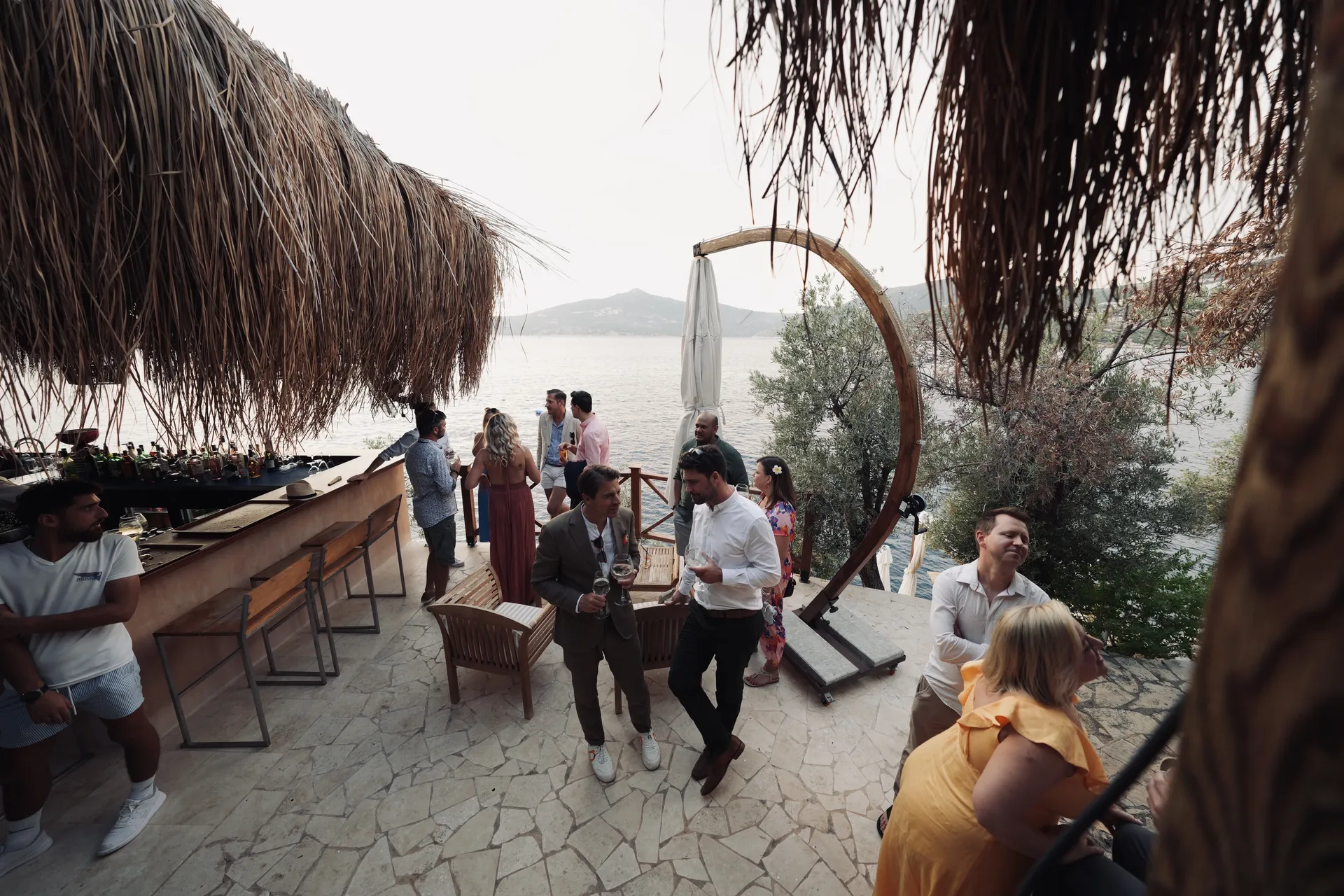 Guests mingling during cocktail hour at Mediterranean beach club
