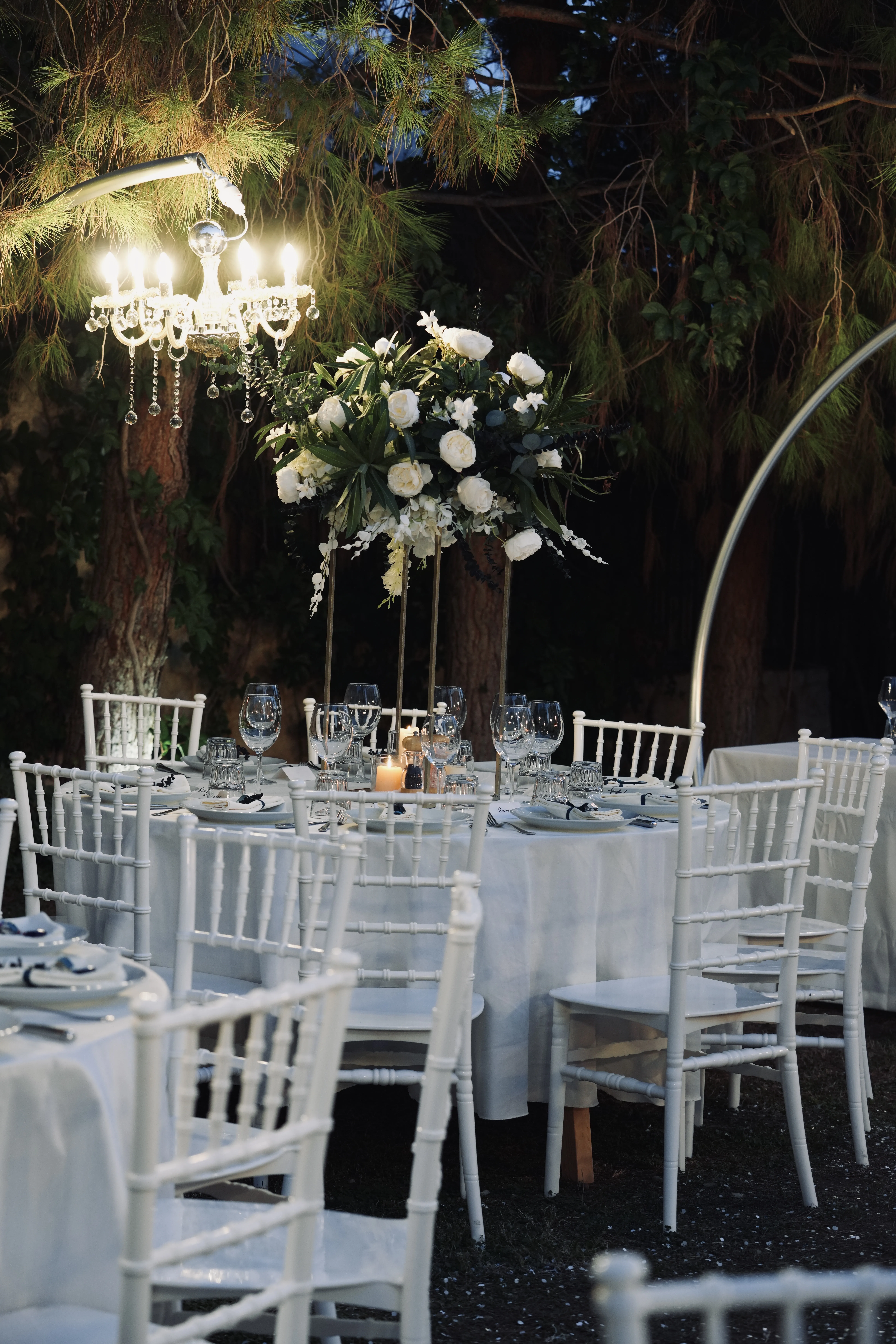 Evening reception table with tall white floral centerpiece