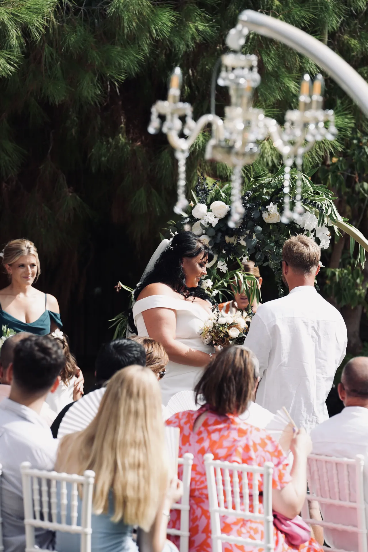 Daytime garden ceremony with suspended crystal chandelier
