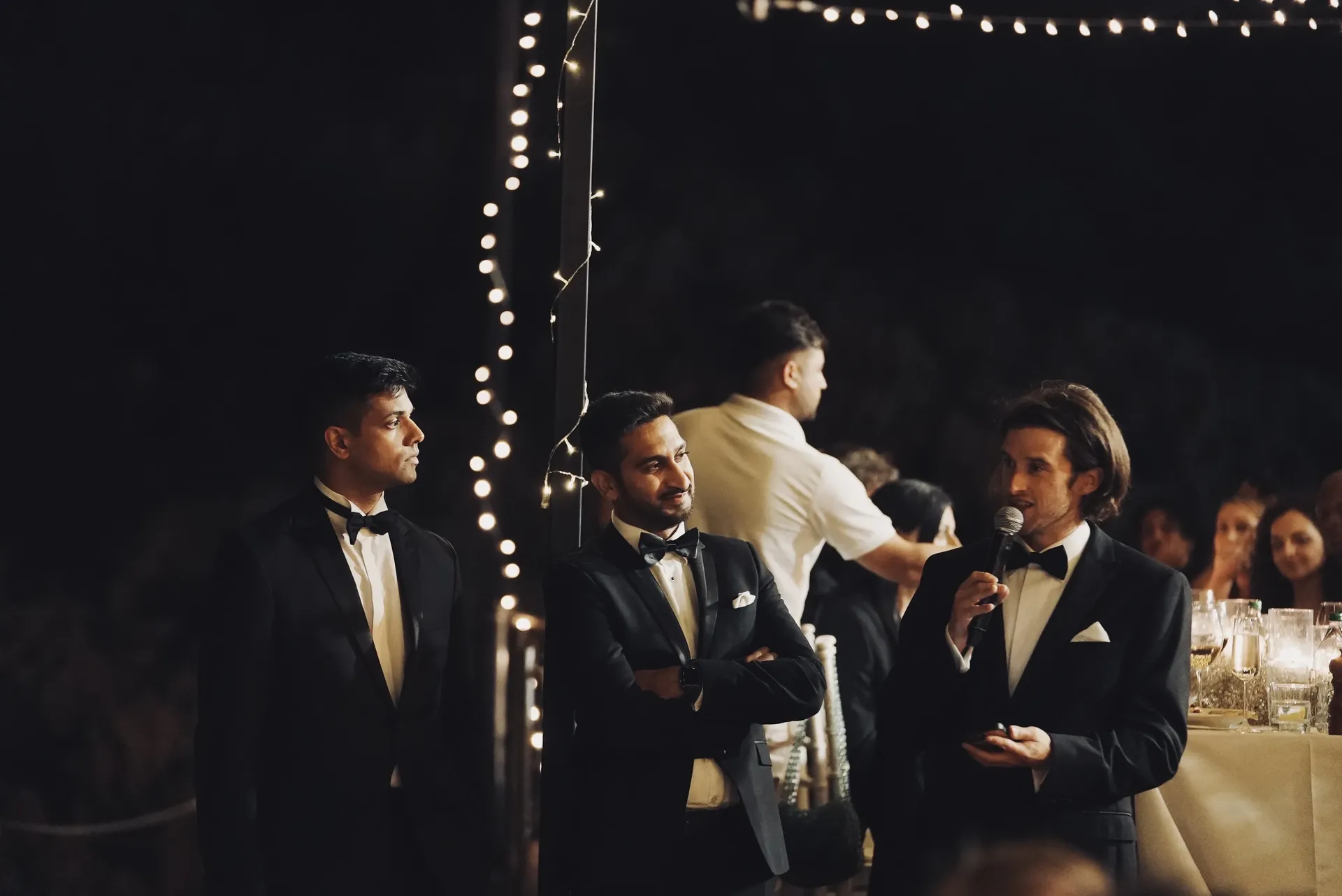 Groomsman giving emotional speech at evening reception
