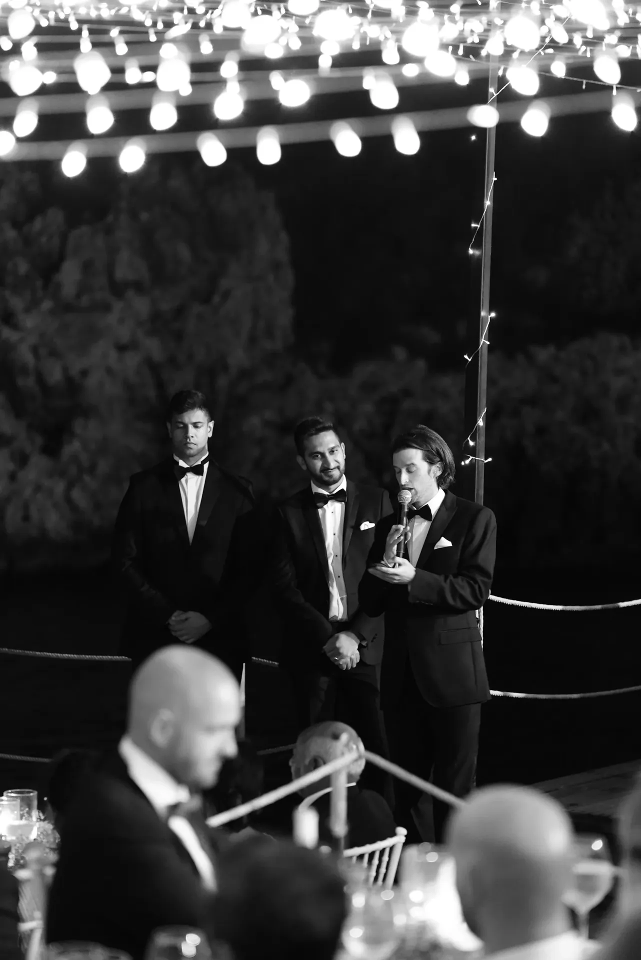 Artistic black and white groomsmen portrait with dramatic bokeh