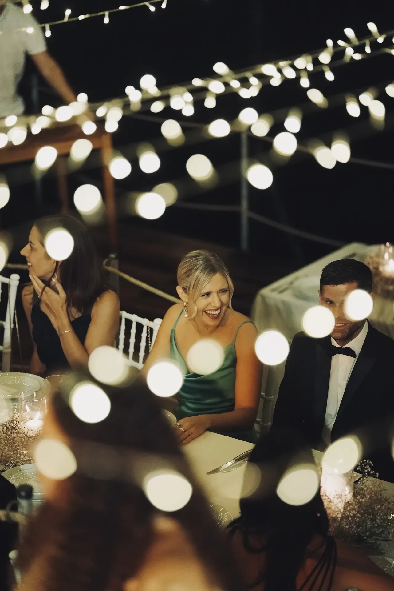 Candid reception moment with creative bokeh light effects