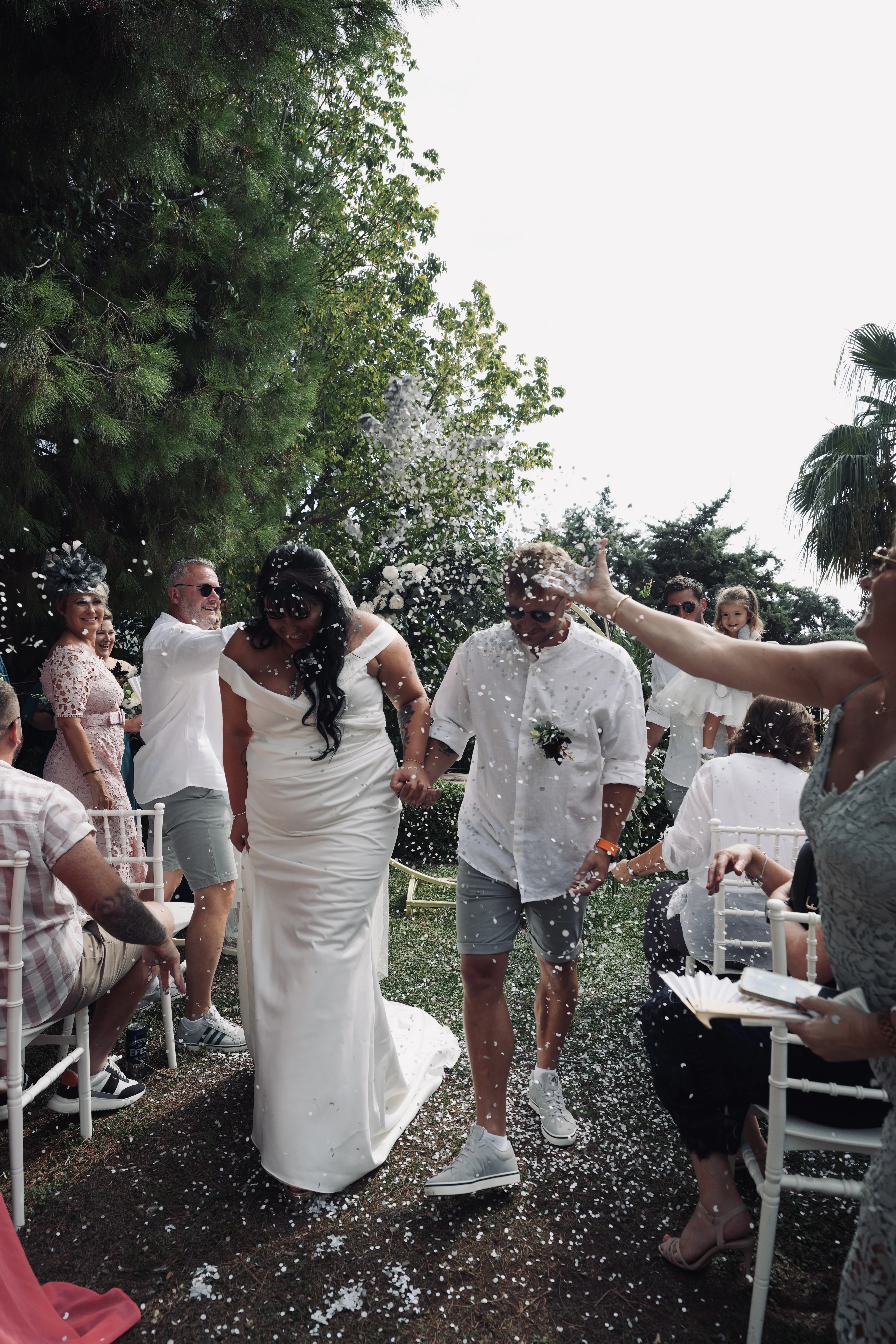 Two brides celebrating with confetti after ceremony